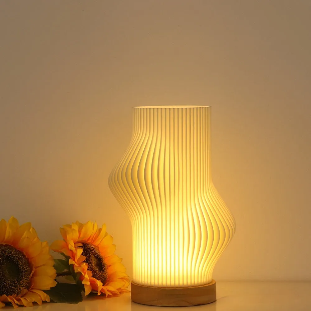 3D printed cylindrical vase night lamp in wood colour finish on a modern bedside table