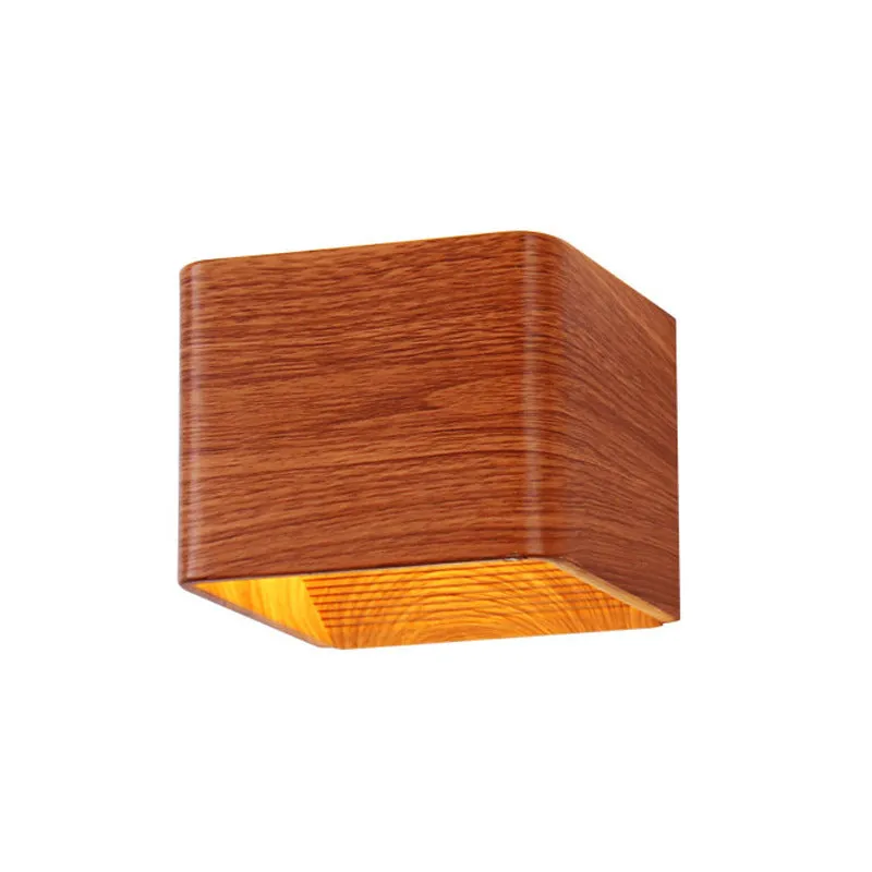 Square LED indoor wall lamp in black die-cast aluminium with warm white light on a wall