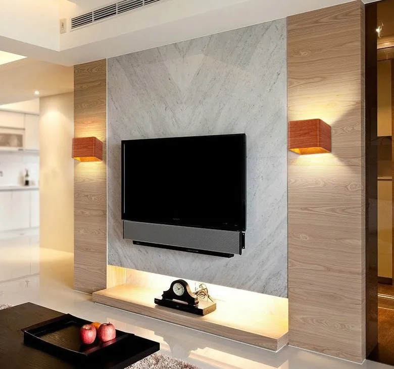 Square LED indoor wall lamp in black die-cast aluminium with warm white light on a wall
