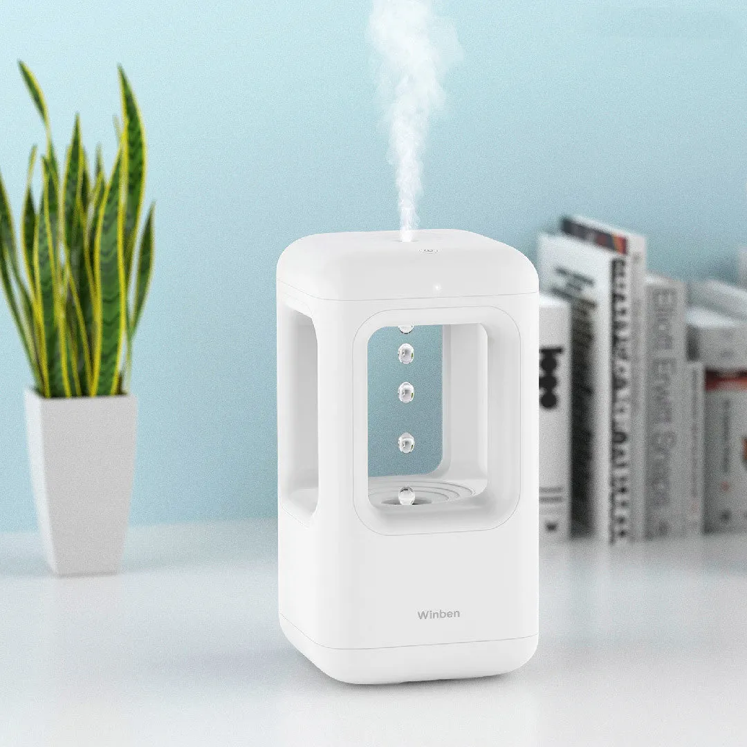 White anti-gravity water drop humidifier with ambient light on bedside table