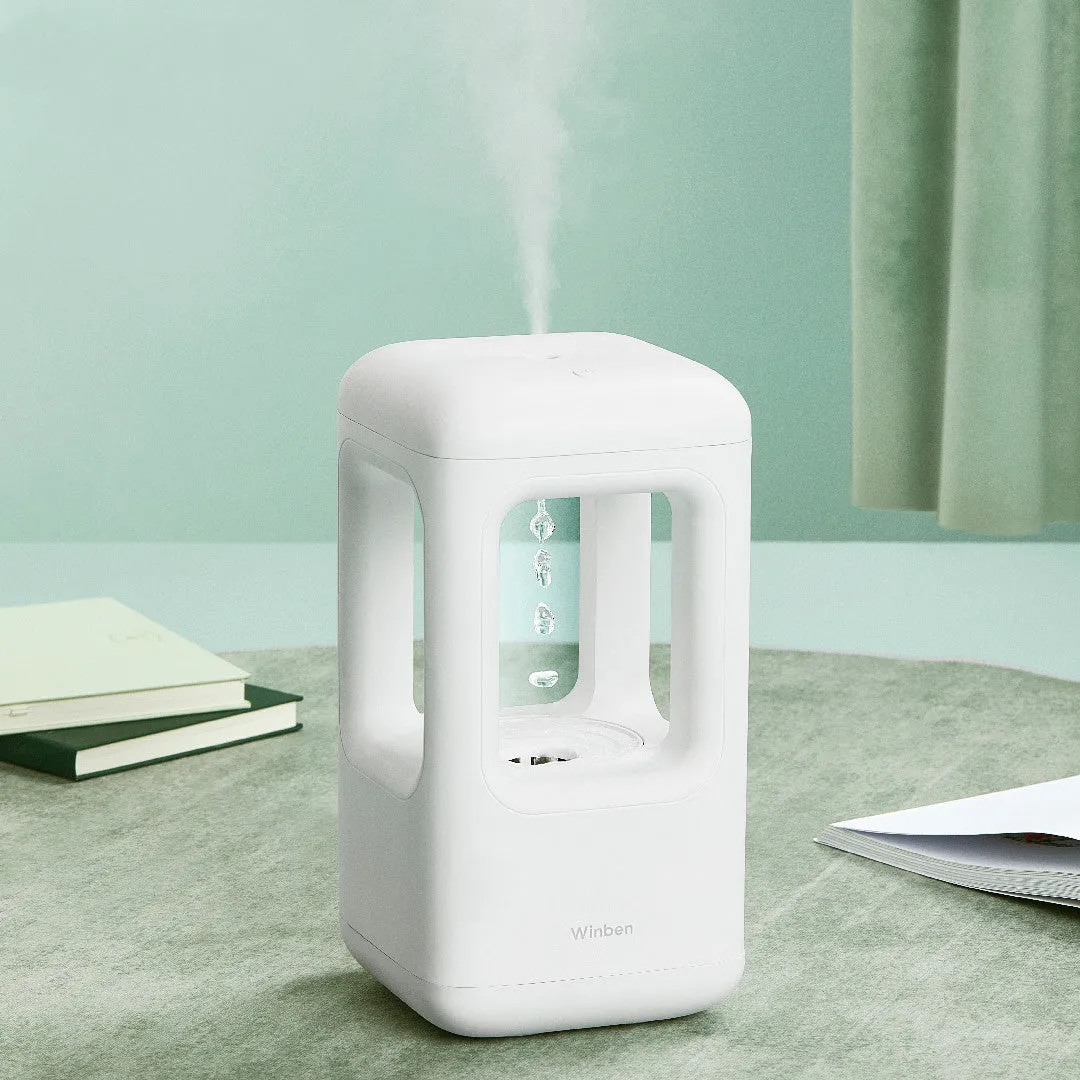 White anti-gravity water drop humidifier with ambient light on bedside table