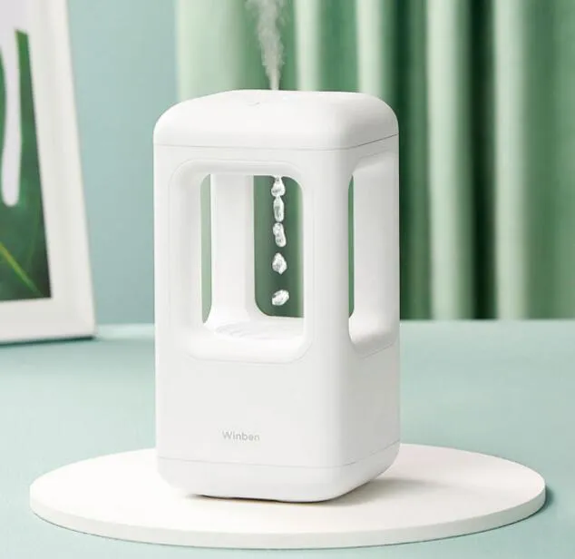 White anti-gravity water drop humidifier with ambient light on bedside table