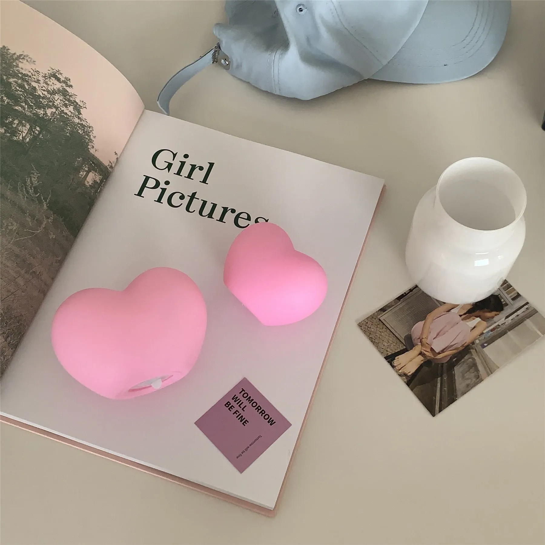 White and pink vinyl atmosphere lamp in trumpet and tuba shapes on a bedside table.