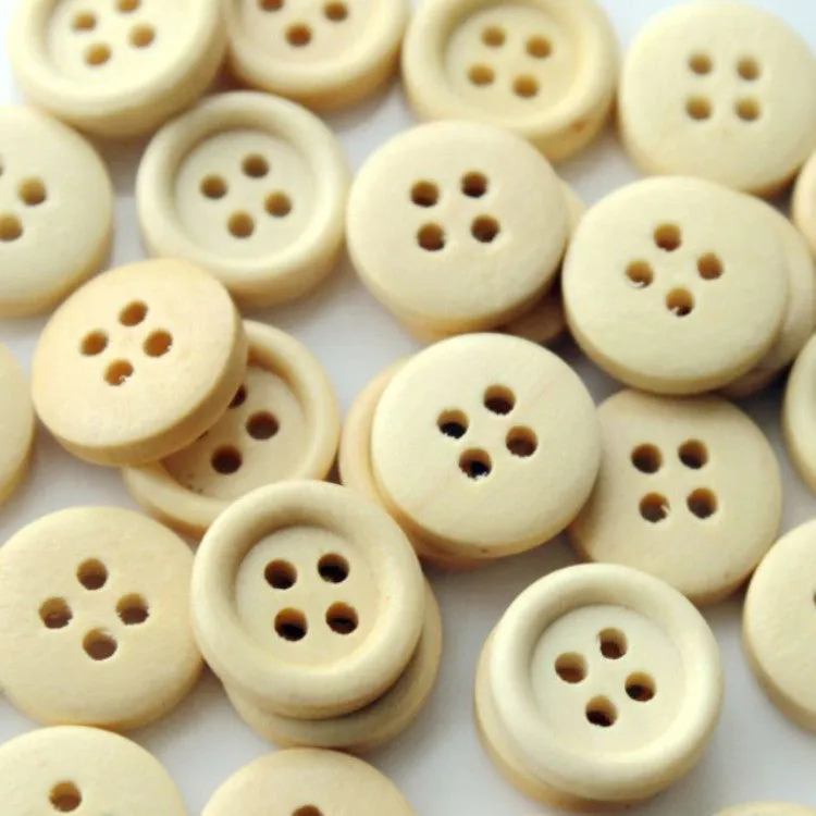 Round natural wood buttons in various sizes 10mm to 30mm on a white background concave flower design