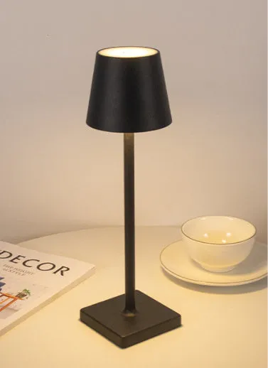 Aluminum LED charging table lamp with touch dimming in black finish on a wooden desk
