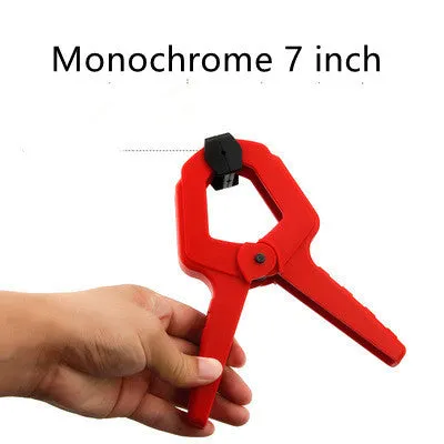 Tool steel woodworking clamp in double colour finish, 7 inch size, on a workbench