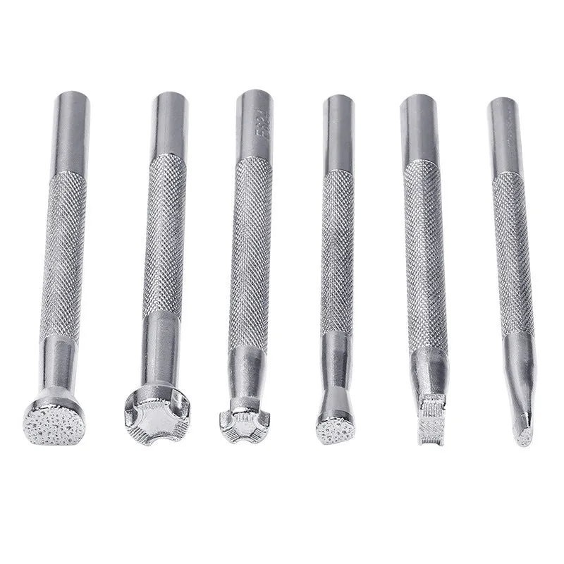 Set of six alloy leather carving printing sticks arranged on a workbench, tools for stamping and embossing