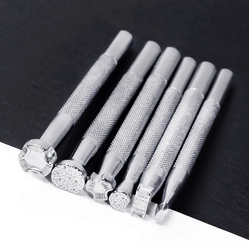 Set of six alloy leather carving printing sticks arranged on a workbench, tools for stamping and embossing