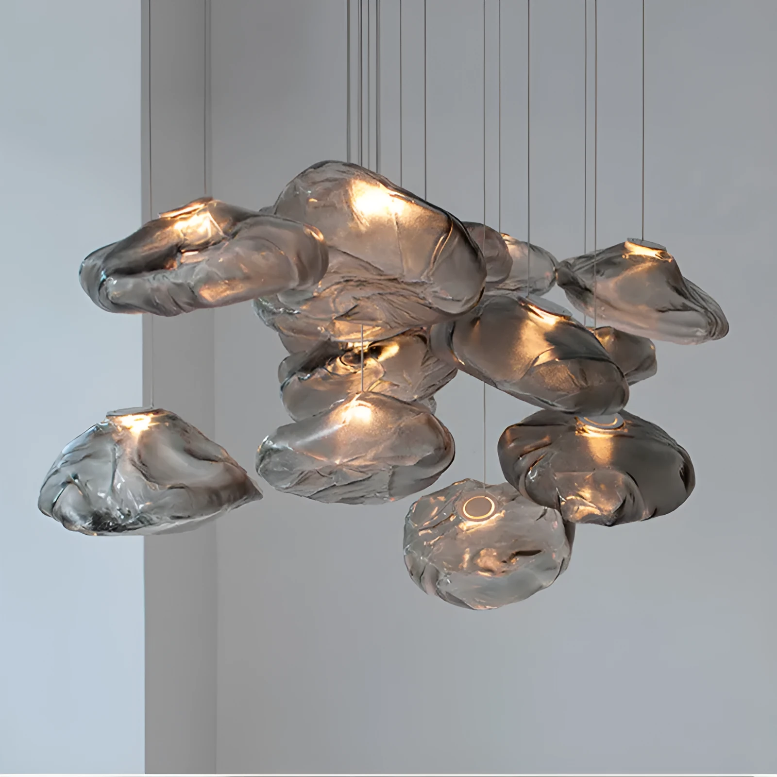 Postmodern style fabric chandelier with glass shade, shown in amber, clear, and smoke grey colours.