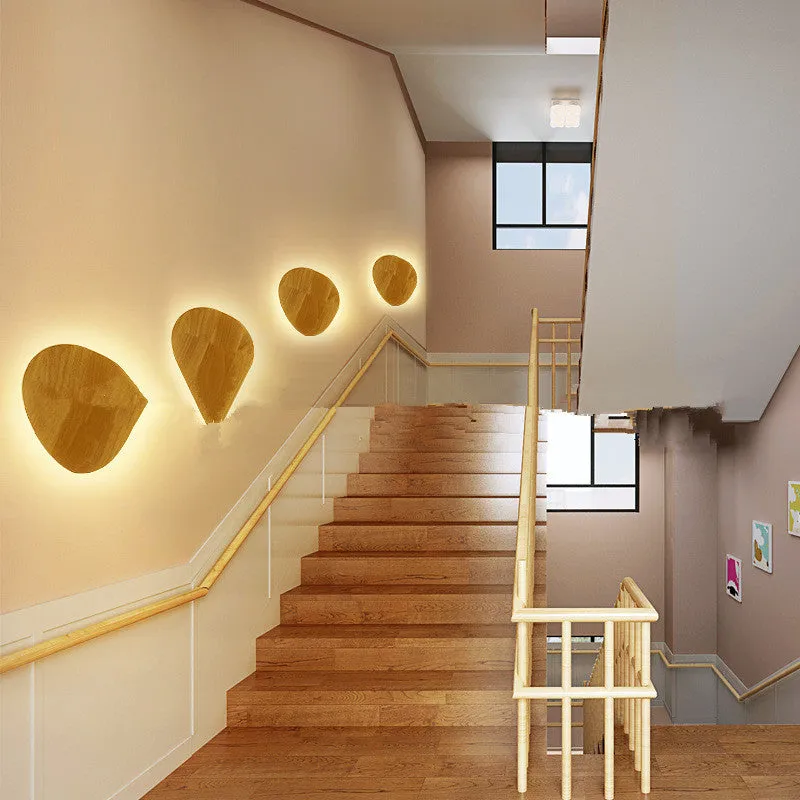 Log Art wood LED wall lamp with oval shape and warm light on a white wall