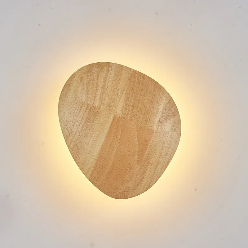 Log Art wood LED wall lamp with oval shape and warm light on a white wall