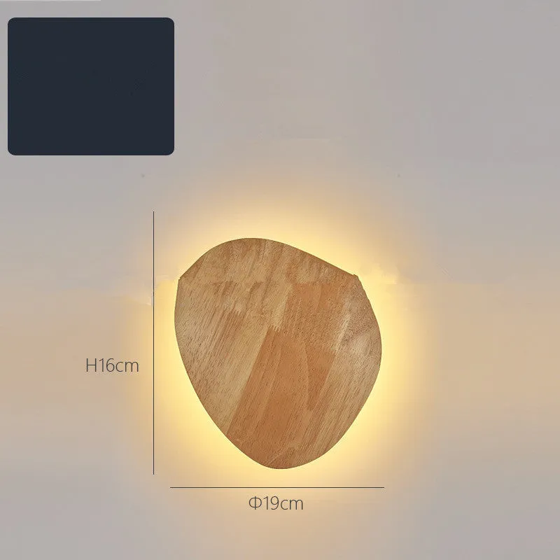 Log Art wood LED wall lamp with oval shape and warm light on a white wall