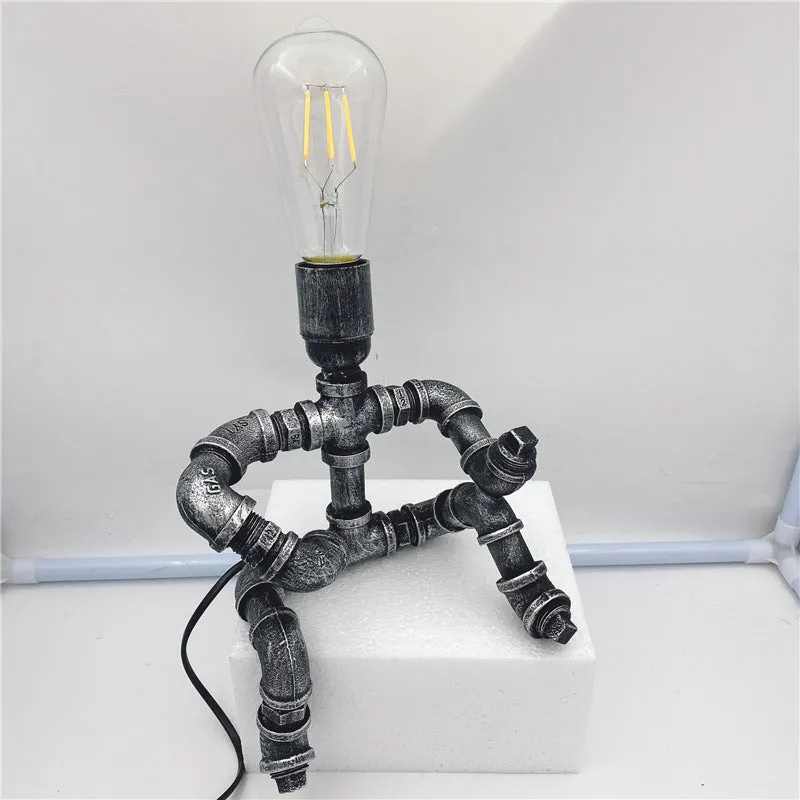 Industrial retro style water pipe robot table lamp made of iron in a vintage colour.
