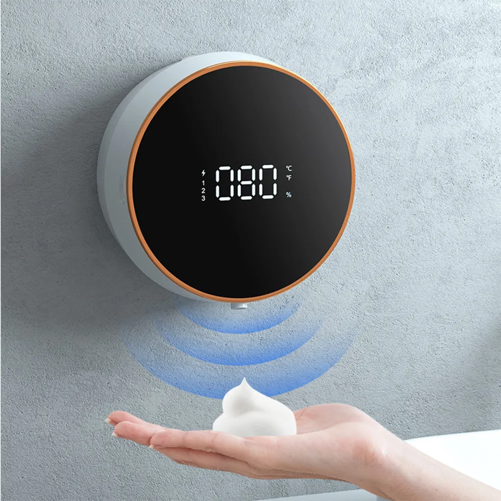 Black automatic sensor foam soap dispenser with USB port mounted on a white bathroom wall.