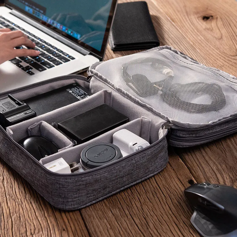 Gray waterproof double-layer electronics organizer bag with adjustable dividers and carrying handle, open to show elastic loops and mesh pockets
