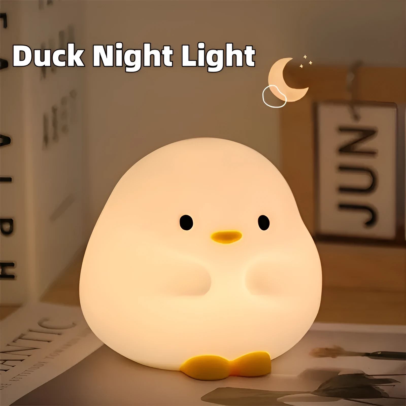 Cute duck-shaped silicone LED night lamp with touch sensor and warm glow on a bedside table