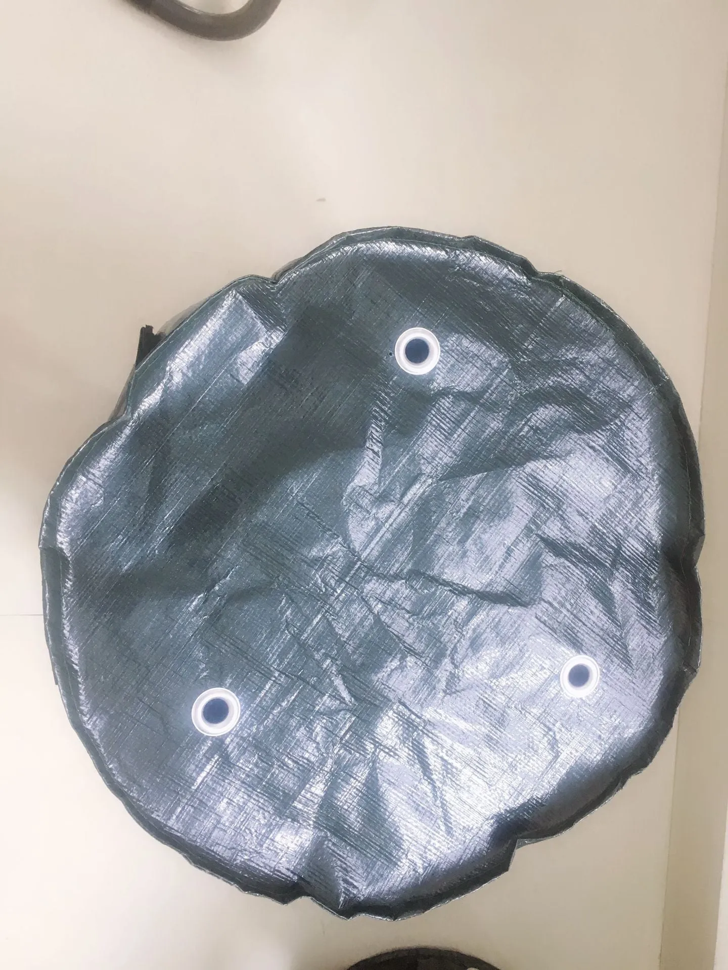 Dark green PE garden planting bag with side windows and double handles on a balcony