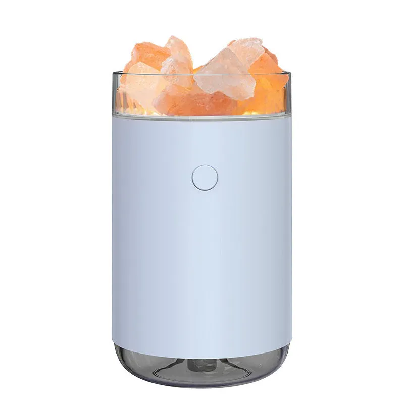 White desktop ultrasonic humidifier with crystal salt stone and LED lamp showing side view on table