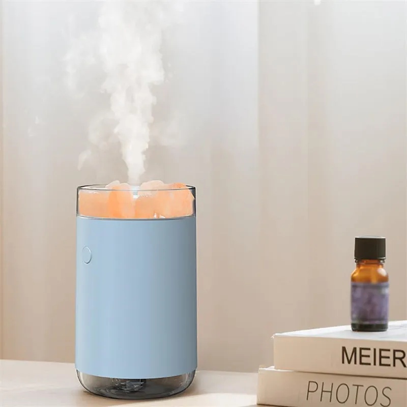 White desktop ultrasonic humidifier with crystal salt stone and LED lamp showing side view on table
