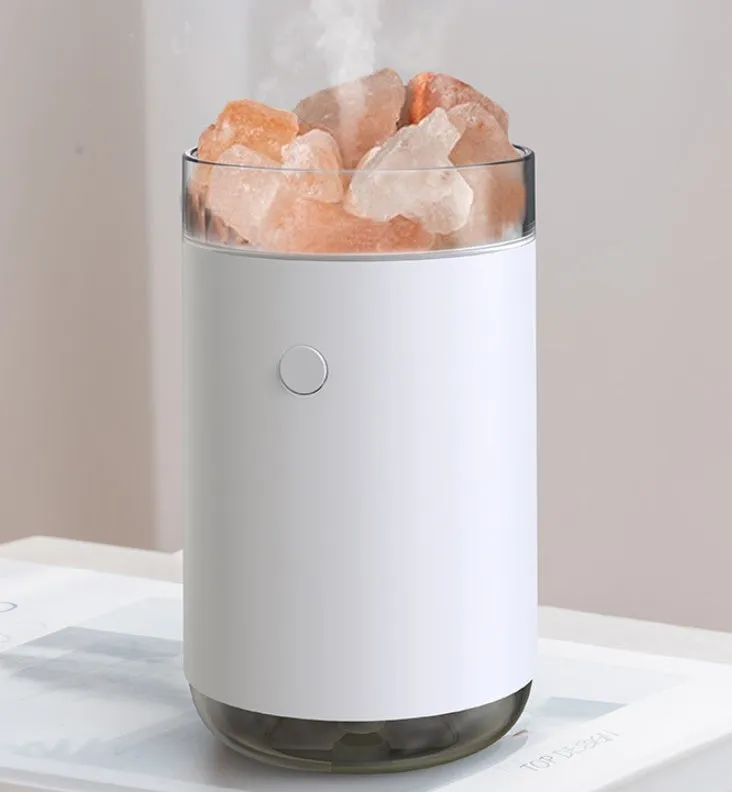 White desktop ultrasonic humidifier with crystal salt stone and LED lamp showing side view on table