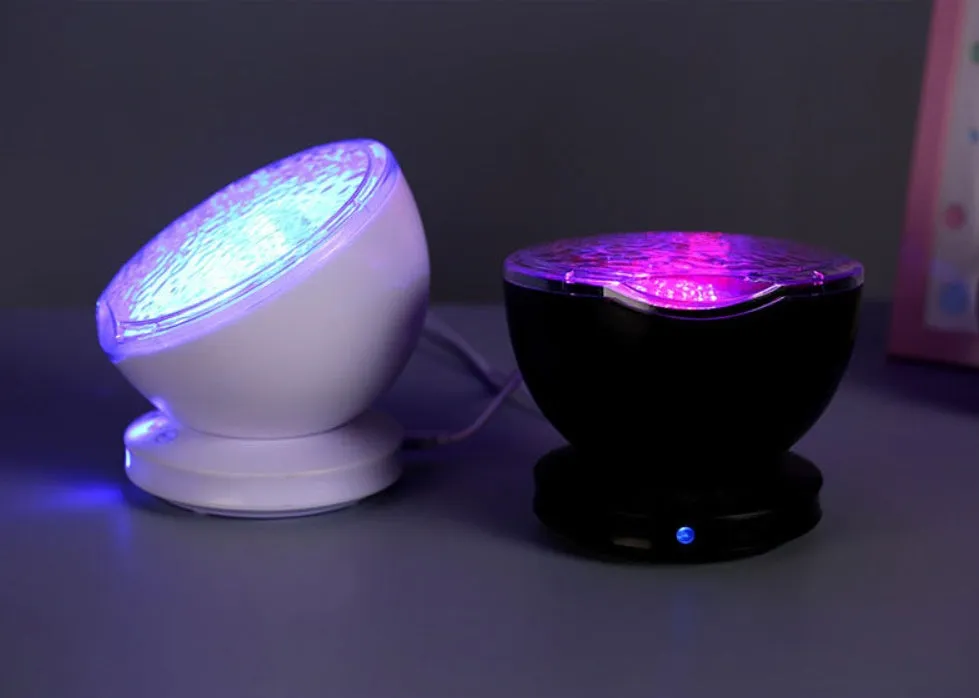 White and blue ocean wave projector LED night light with remote control, measuring 13x12x12 cm