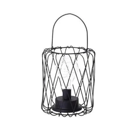 Hollow wrought iron wine bottle shaped table lamp with warm white LED light on a wooden desk