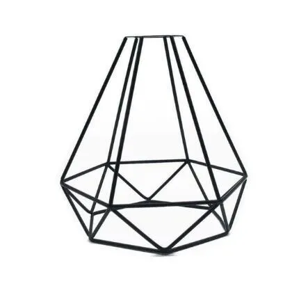 Hollow wrought iron wine bottle shaped table lamp with warm white LED light on a wooden desk