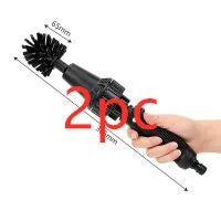 Water-driven rotary cleaning brush in black and yellow plastic connected to a garden hose for car wheel cleaning