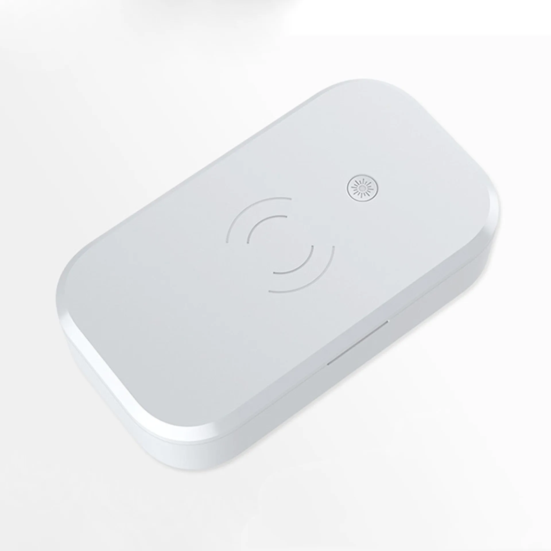 White ultraviolet disinfection box with wireless phone charging pad on top.