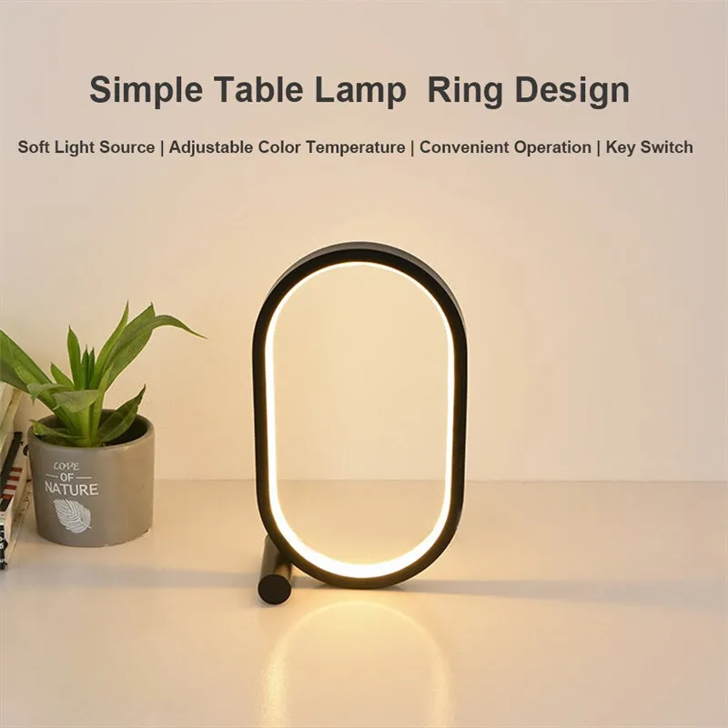 USB plug-in oval acrylic touch dimmable night light with metal base on a desk, black colour