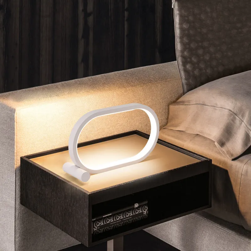 USB plug-in oval acrylic touch dimmable night light with metal base on a desk, black colour