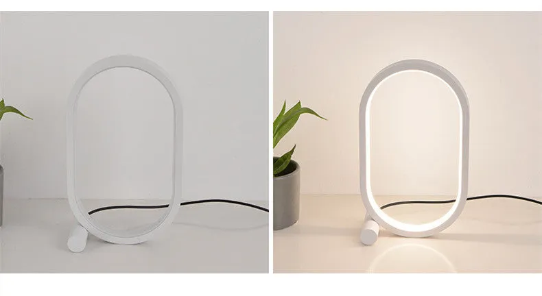 USB plug-in oval acrylic touch dimmable night light with metal base on a desk, black colour