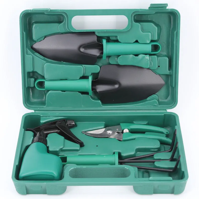 Ten-piece gardening tool set with iron heads and green plastic handles on a wooden background