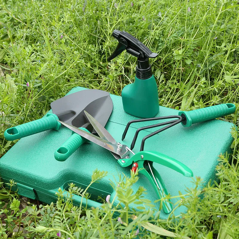 Ten-piece gardening tool set with iron heads and green plastic handles on a wooden background