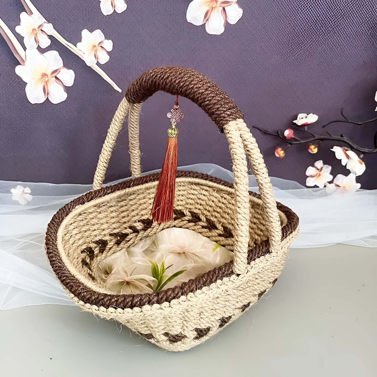 Small hand-woven straw storage basket in brown, measuring 19cm wide.
