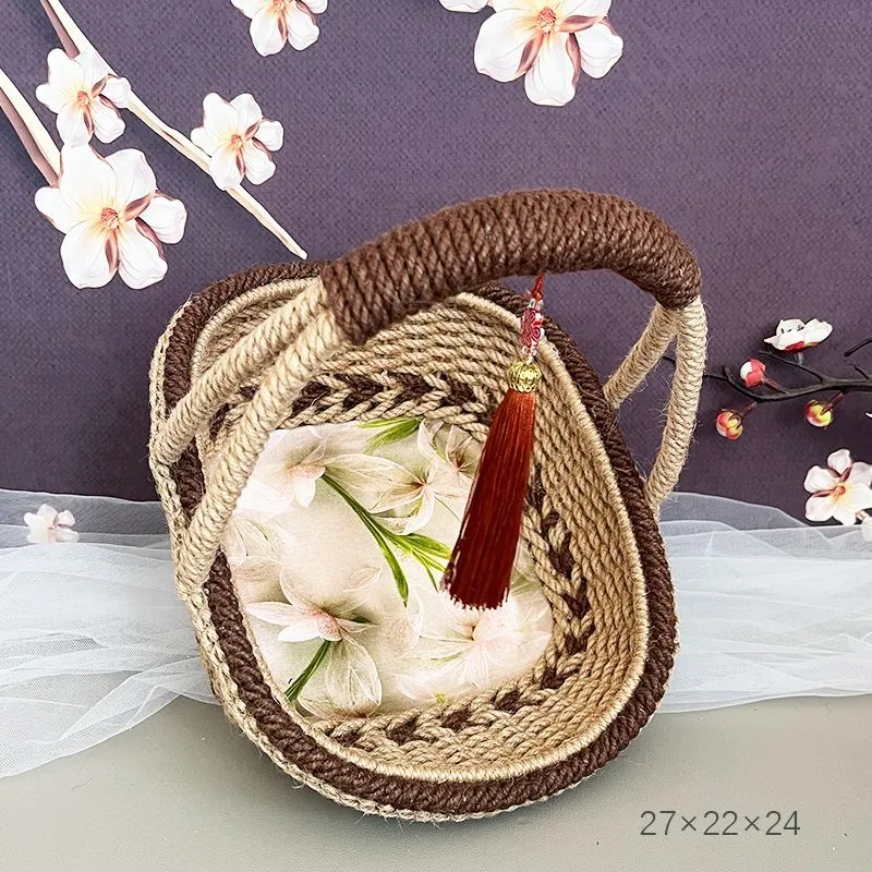 Small hand-woven straw storage basket in brown, measuring 19cm wide.