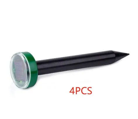 Solar ultrasonic mouse repeller with black solar panel and battery unit on grassy ground