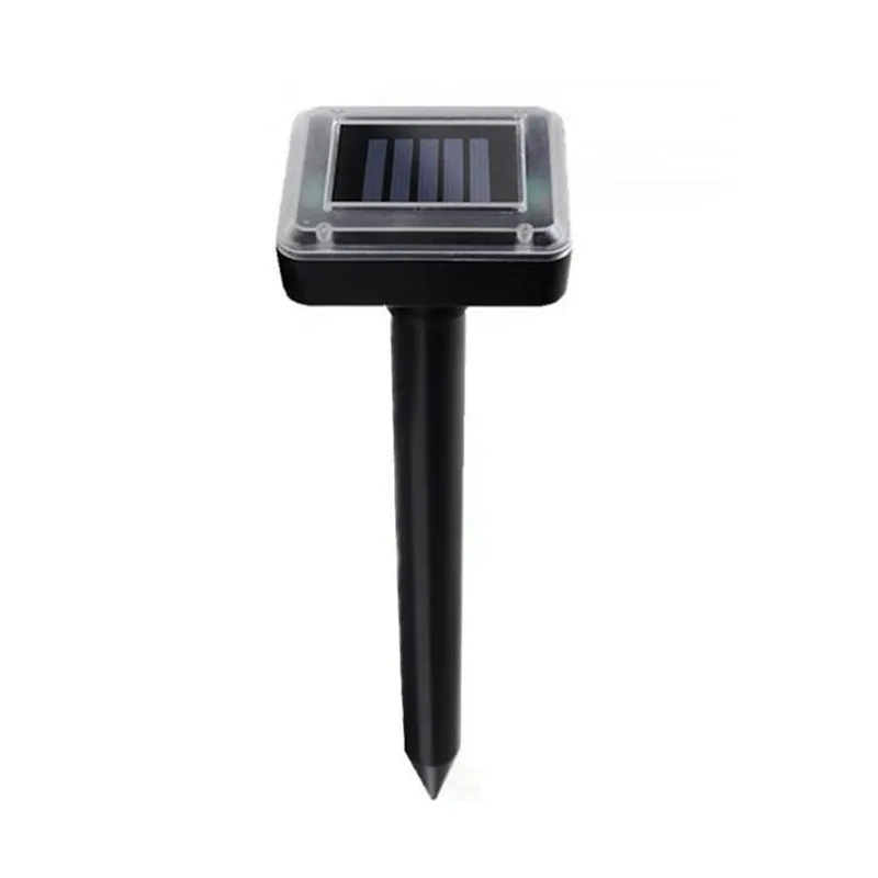 Solar ultrasonic mouse repeller with black solar panel and battery unit on grassy ground