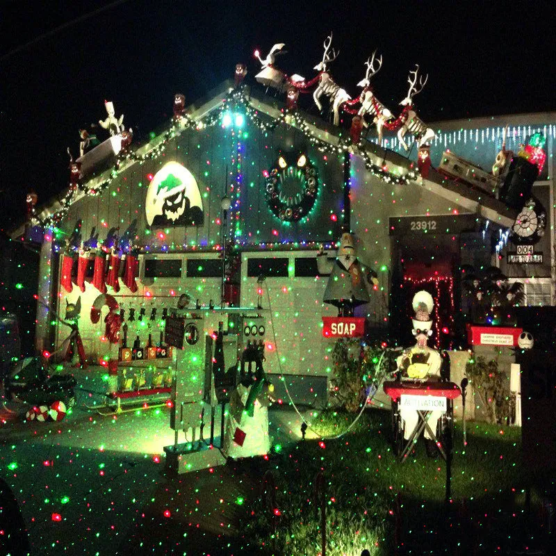 Christmas laser projector projecting red and green laser firefly patterns onto a garden tree at night, IP65 outdoor use