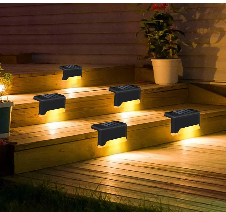 Black solar stair light with ABS housing on outdoor steps, 75x44x42mm IP55 rated