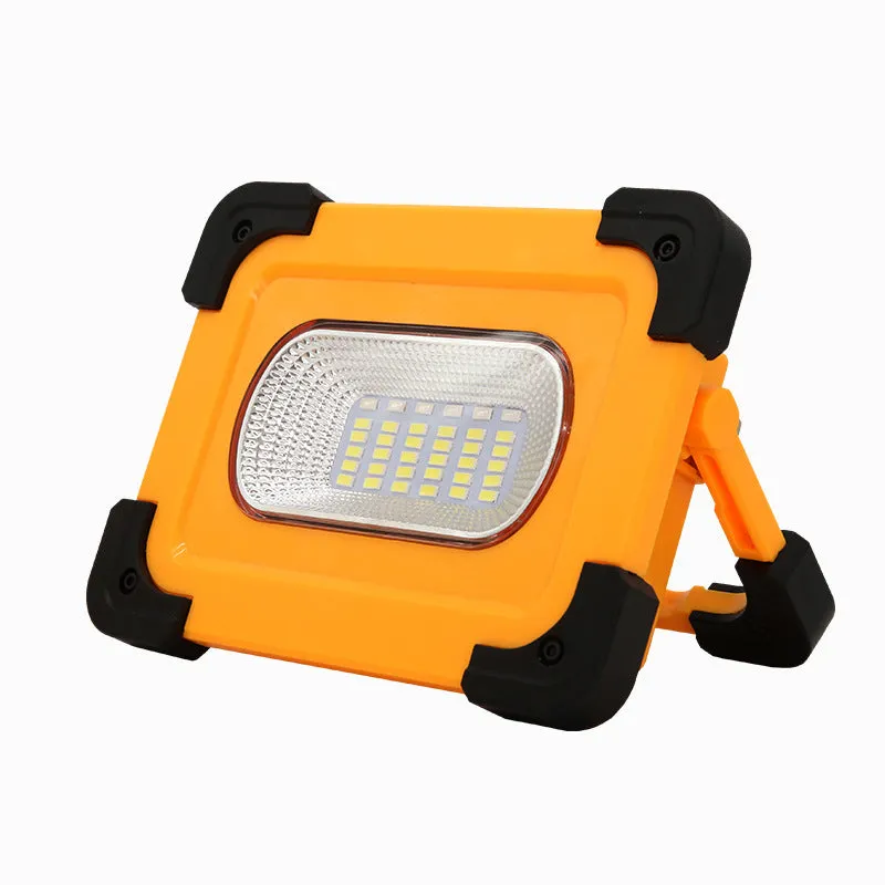Yellow outdoor portable solar LED light with power bank and magnetic base, 36LED lamp beads model 5730, sitting on a metal surface