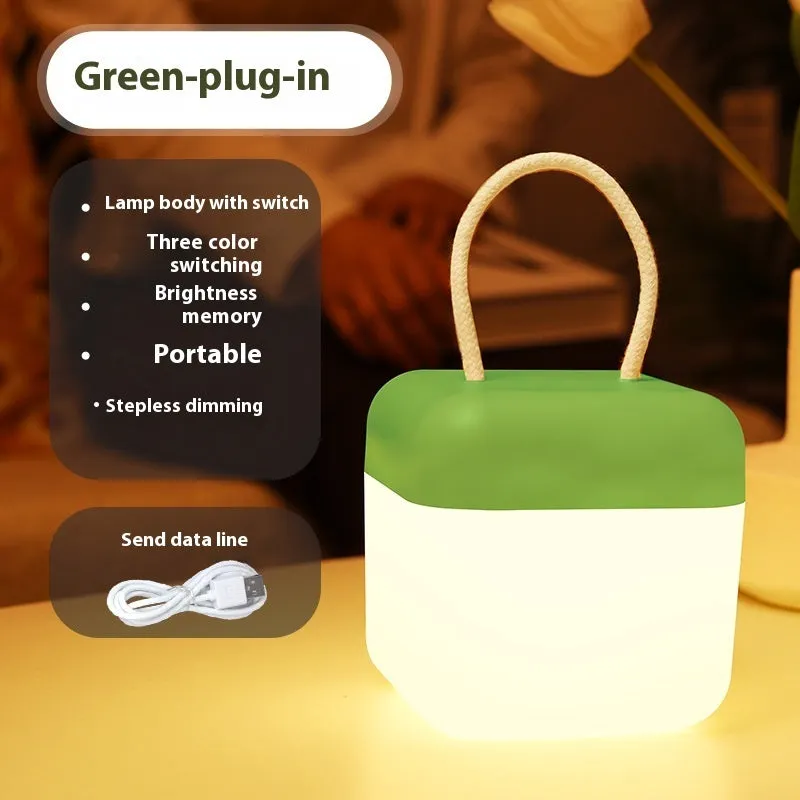 LED hanger solid color portable rechargeable light in green with remote control on a table