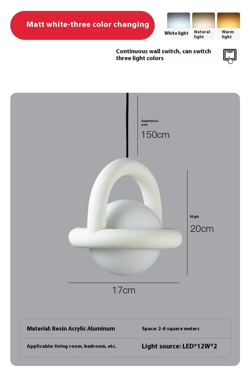Matte black hanging line lamp with a long black cord suspended above a bedside table.