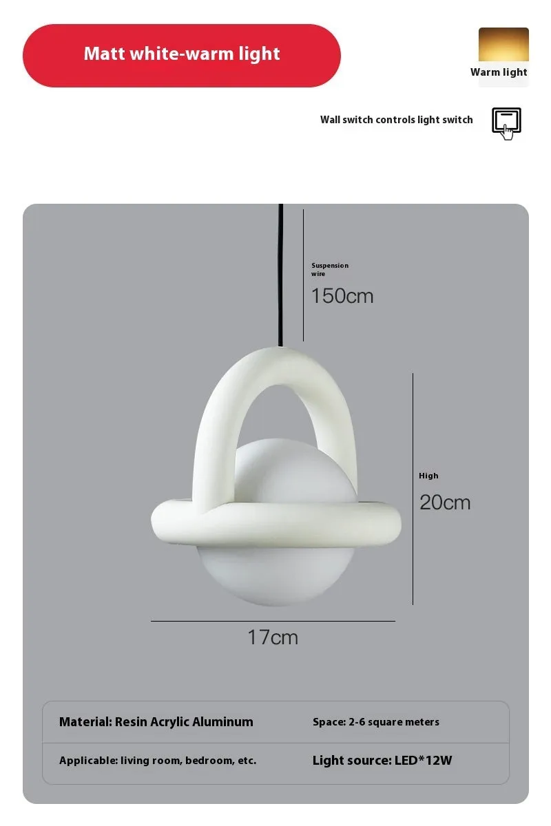 Matte black hanging line lamp with a long black cord suspended above a bedside table.