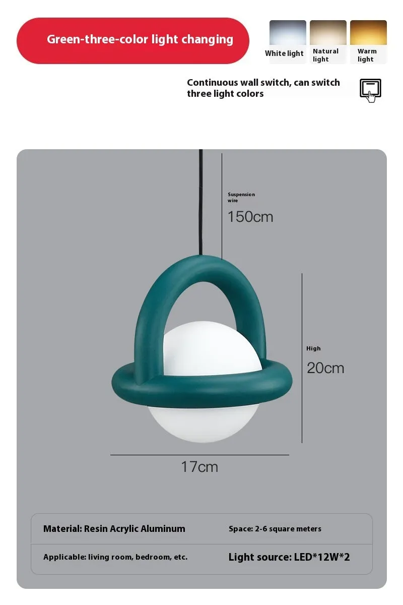 Matte black hanging line lamp with a long black cord suspended above a bedside table.