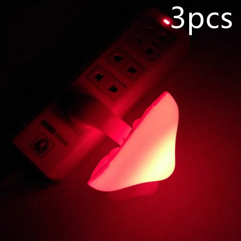 Mushroom-shaped LED night light with light sensor, warm yellow glow, plugging into a wall socket