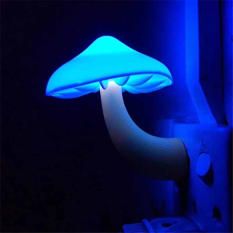 Mushroom-shaped LED night light with light sensor, warm yellow glow, plugging into a wall socket