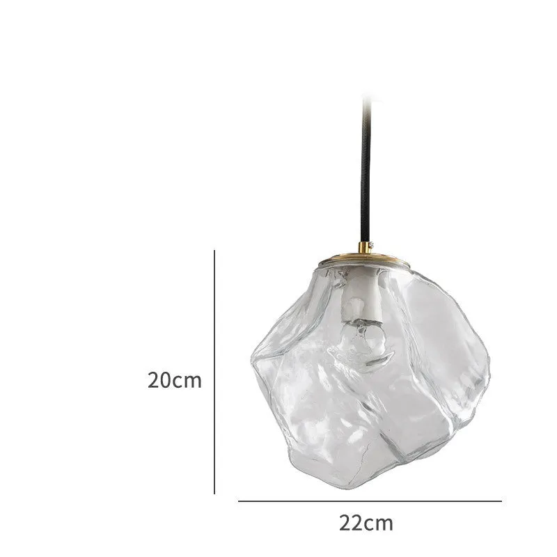 Minimalist ice cube glass chandelier with warm 4000K light, smoky grey shade and black hanging wire over a dining table