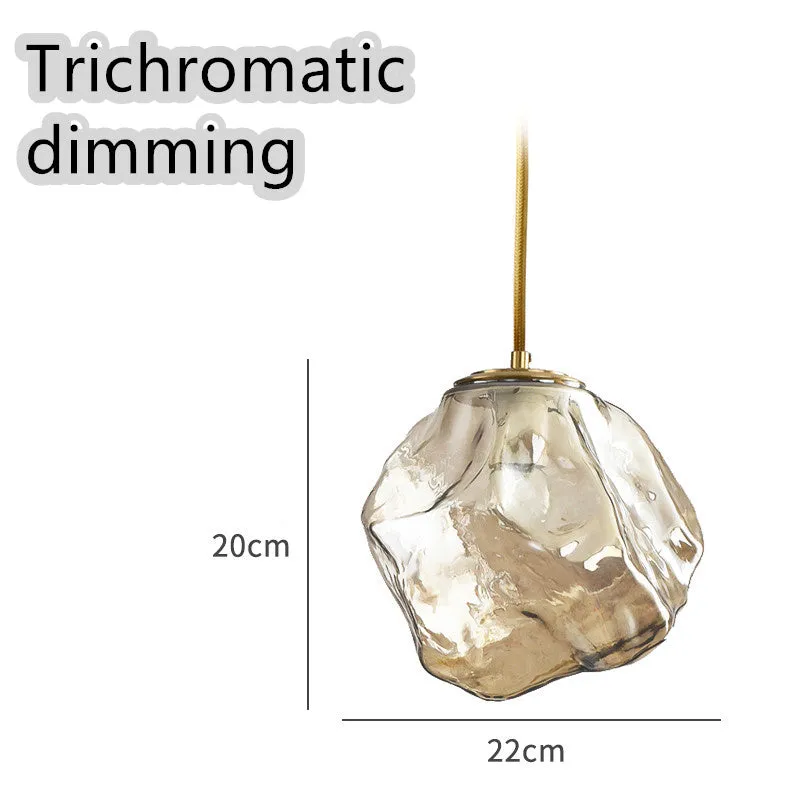 Minimalist ice cube glass chandelier with warm 4000K light, smoky grey shade and black hanging wire over a dining table
