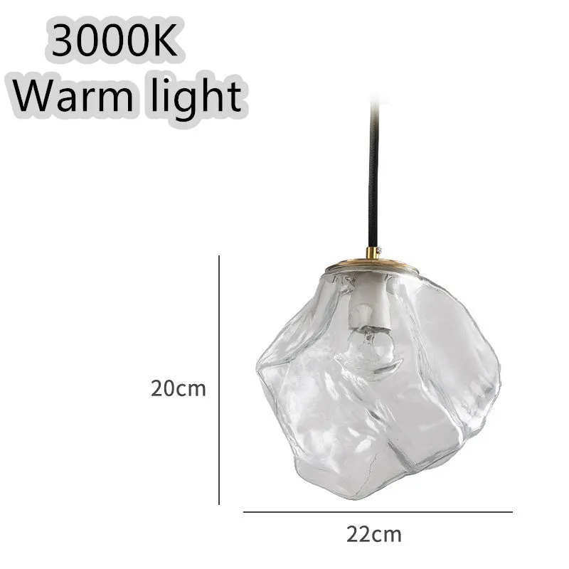 Minimalist ice cube glass chandelier with warm 4000K light, smoky grey shade and black hanging wire over a dining table